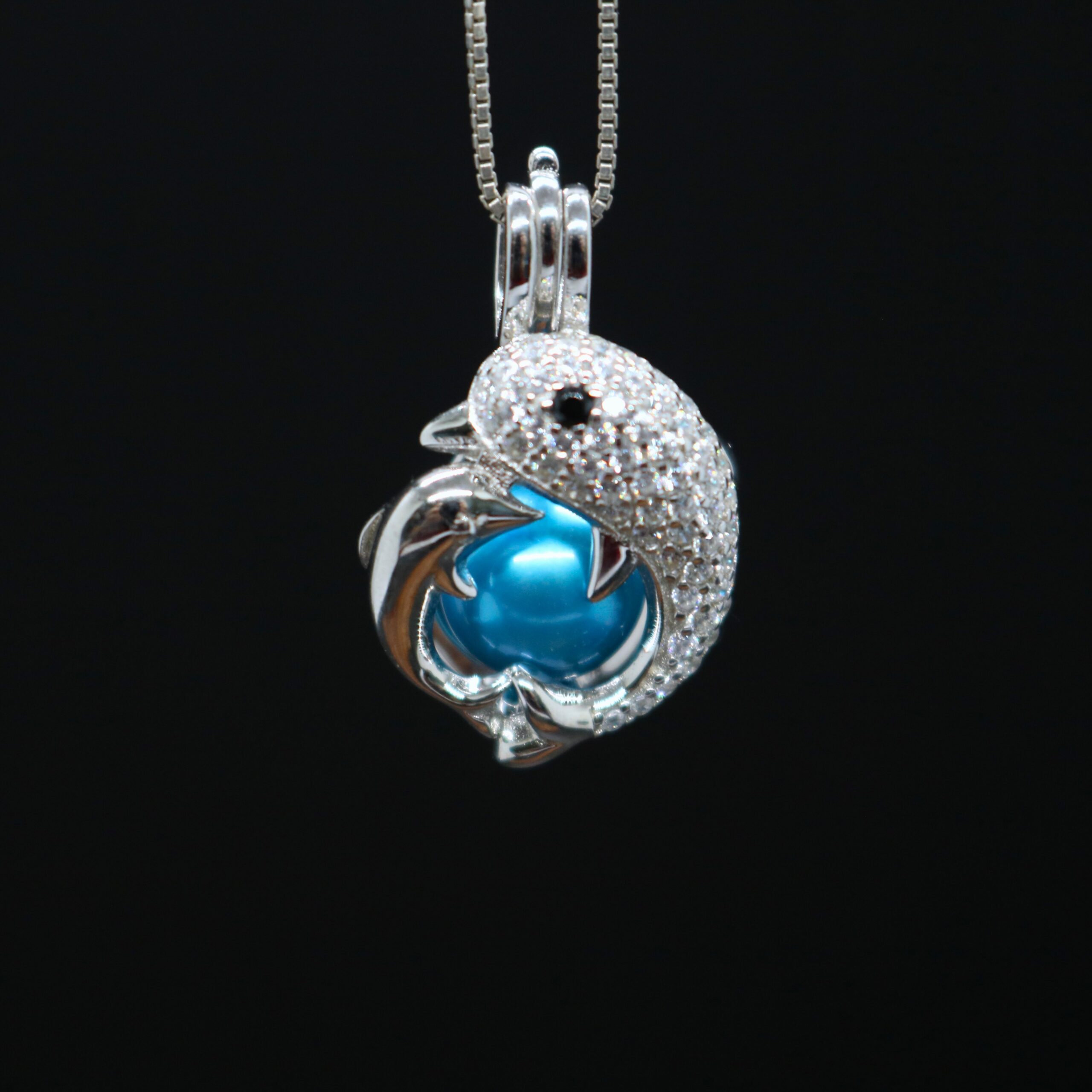 sterling silver pearl locket with two dolphins around pearl