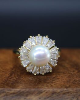 pearl ring surrounded by clear stones