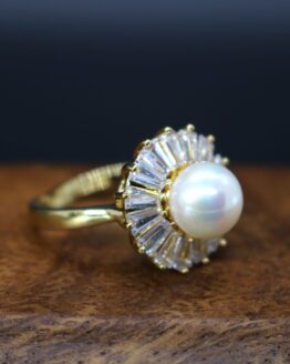 pearl ring surrounded by clear stones