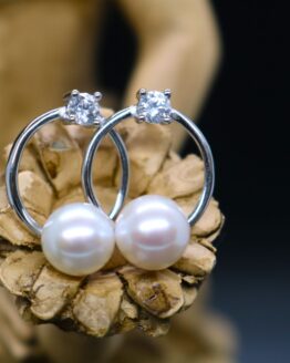 sterling silver round earring has a pearl on the bottom of the ring and a cz on the top; called the sunset earrings